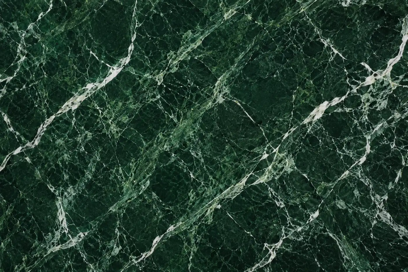 Verde Alpi marble with layered white veining on a rich green surface